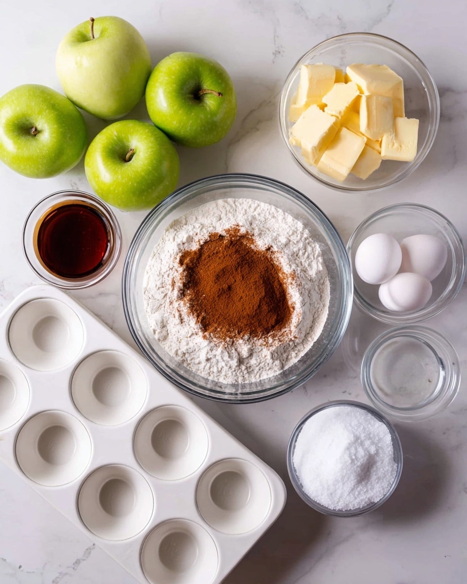 The image shows a clear glass bowl filled with white flour and brown cinnamon layered on top, placed on a white marbled surface. Next to it is a white muffin tray holding two green apples on the left, two white eggs in the middle, a small bowl with dark brown vanilla extract on the top left side of the tray, a small white bowl of salt on the right side, and a larger white bowl filled with white sugar at the bottom left. Behind all these ingredients is a clear bowl with yellow butter pieces. Everything is arranged neatly on the white marbled surface. photo taken with an iphone --ar 4:5 --v 7