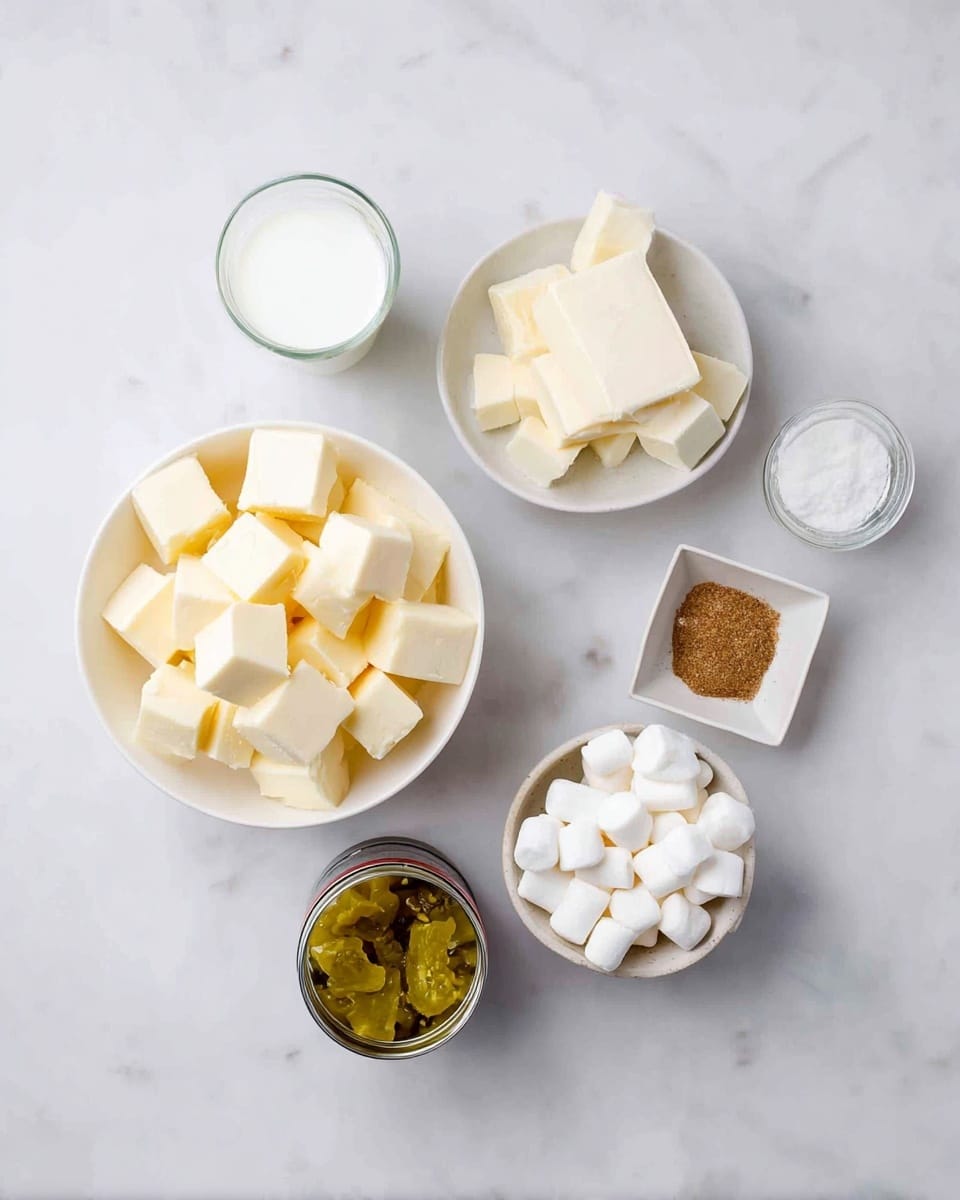 A top view of multiple white bowls on a white marbled surface, each containing different ingredients: one large bowl filled with pale yellow cubes of butter, one smaller bowl filled with white cubed marshmallows, one tiny square dish holding a small block of butter, a small glass jar with a brown spice inside, and two clear glasses, one with white milk and the other with a transparent liquid, plus a small open can filled with chopped yellow pickles. photo taken with an iphone --ar 4:5 --v 7