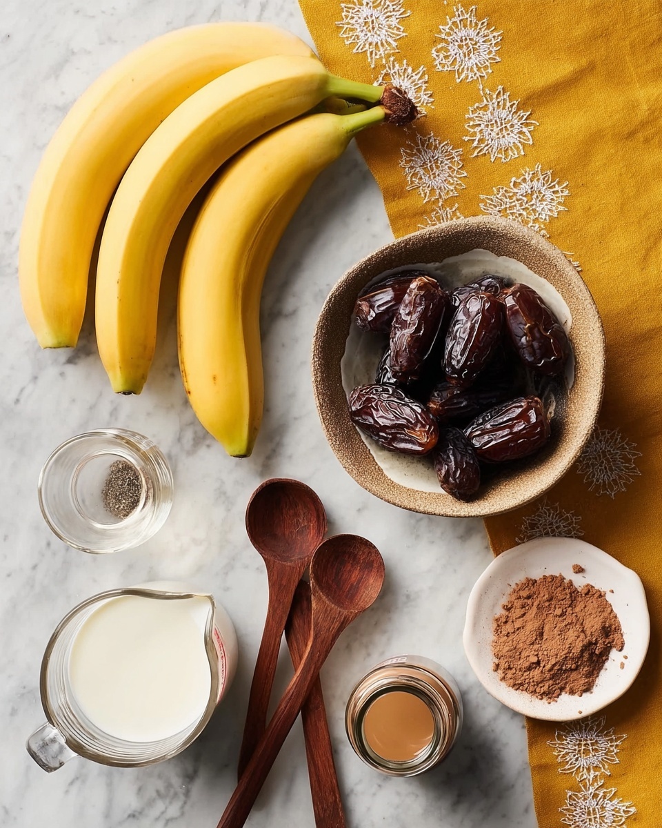 Coffee Smoothie with Bananas and Almond Butter Recipe 4 A white marbled surface holds a cluster of three yellow bananas at the top left, slightly angled. Below and slightly to the right, a small, round bowl with a textured outer surface contains dark brown, wrinkled dates. To the left of this bowl, three wooden measuring spoons are stacked with the largest on the bottom. Near the bottom left, a glass measuring cup is filled with white milk. At the center bottom, a small bottle holds a dark liquid, while the top right shows an open jar with light brown creamy contents and next to it a white dish with a heap of brown powder. A mustard yellow cloth with white embroidery edges the top part of the image. Photo taken with an iphone --ar 4:5 --v 7