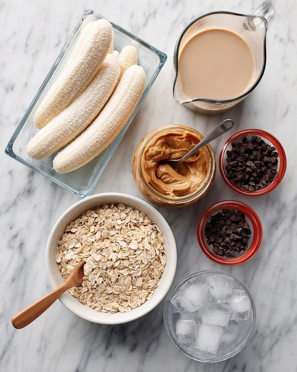 The image shows a white marbled surface with several ingredients arranged neatly. In the top left, there is a clear glass rectangular container holding four peeled frozen bananas with a dusting of frost. Below it is a white round bowl filled with rolled oats and a wooden spoon resting on top. To the right of the bananas, there is an open jar of peanut butter with a metal spoon dipped inside. Near the peanut butter, there is a small glass jar filled with small dark chocolate chips with a red lid resting beside it. In front of the chocolate chips is a transparent bowl with ice cubes. A glass pitcher filled with a light-colored liquid is placed at the top right corner. Dark chocolate chips are scattered loosely on the surface near the jars. photo taken with an iphone --ar 4:5 --v 7