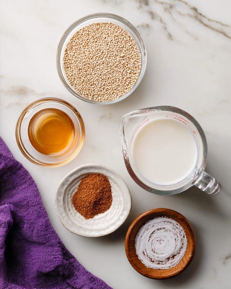 The image shows five containers with ingredients arranged on a white marbled surface. At the top right is a clear glass measuring cup filled with white milk. Below and to the left of it is a small clear glass bowl holding light brown quinoa seeds. To the left of the quinoa is a small clear glass bowl filled with golden brown honey. Below the honey is a small white dish with reddish-brown cinnamon powder. At the bottom right is a small wooden dish with white coarse salt arranged in a spiral pattern. A purple cloth napkin is placed at the top left corner. Photo taken with an iphone --ar 4:5 --v 7