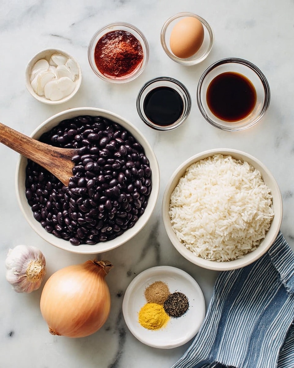 The image shows a white marbled surface with various cooking ingredients arranged neatly. At the center, there is a large white bowl filled with shiny black beans, with a wooden spoon resting inside. To the right is a smaller white bowl full of white rice, placed on top of a blue and white striped cloth. Surrounding these are smaller white bowls and glass containers holding dark soy sauce, a red sauce, yellow powdered spice, and black pepper arranged in a spiral on a small white plate. At the bottom left, there is a bulb of garlic, a whole light brown onion, and a single brown egg. The scene is clean and bright with soft natural lighting, photo taken with an iphone --ar 4:5 --v 7